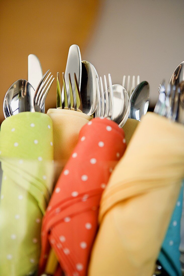 Cutlery wrapped in coloured napkins