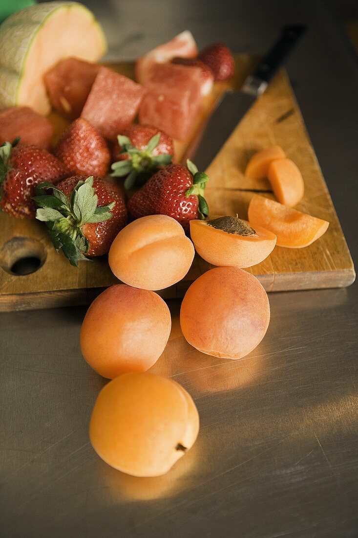 Apricots, Strawberries and Melon on a Wooden Board