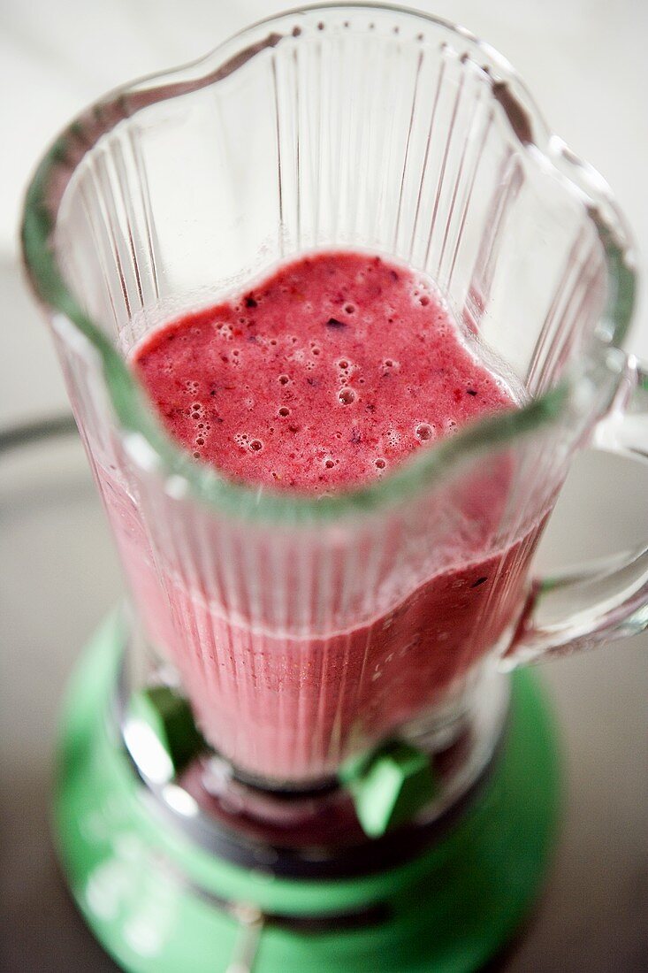 Fruit yoghurt smoothie in liquidiser (overhead view)