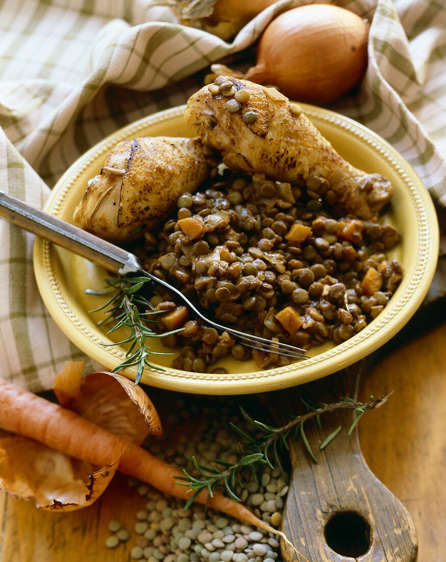Plate of Lentils with Carrots and Two Chicken Drumsticks; Fork; Ingredients