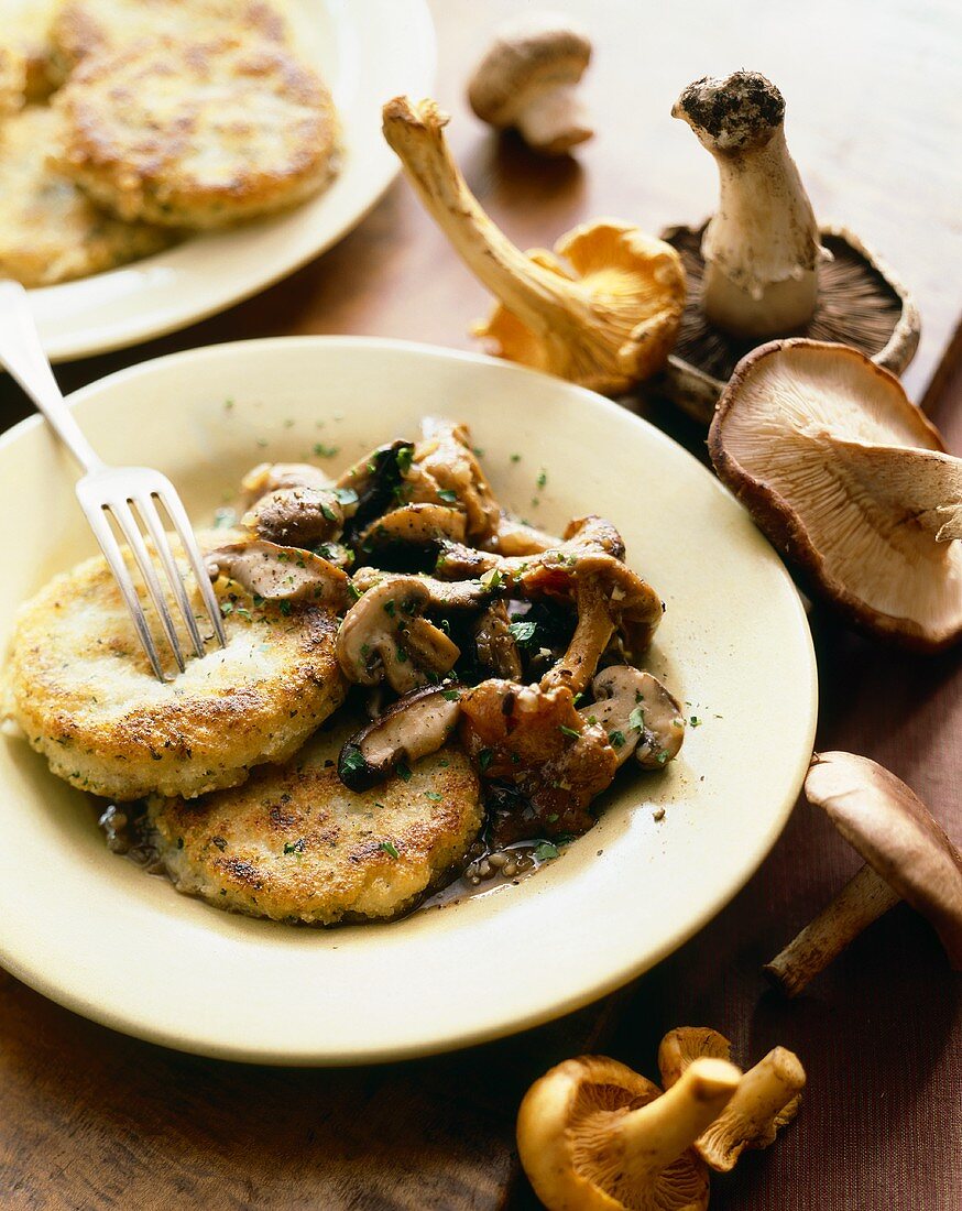 Polenta Cakes with Wild Mushrooms on a Plate with Fork; Mushrooms
