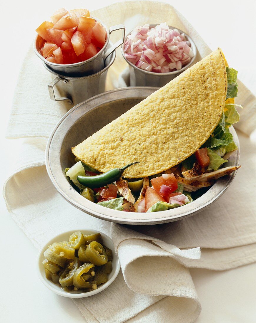 Roast Chicken Taco in a Bowl, Small Bowls of Toppings, Jalapeno Slices, Tomatoes and Red Onion