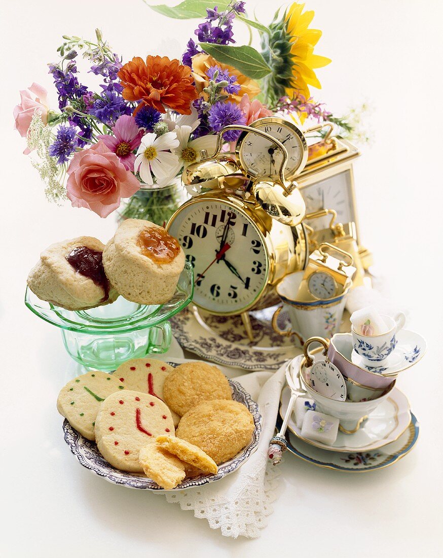 Tea Time Items with Clocks and Pastries