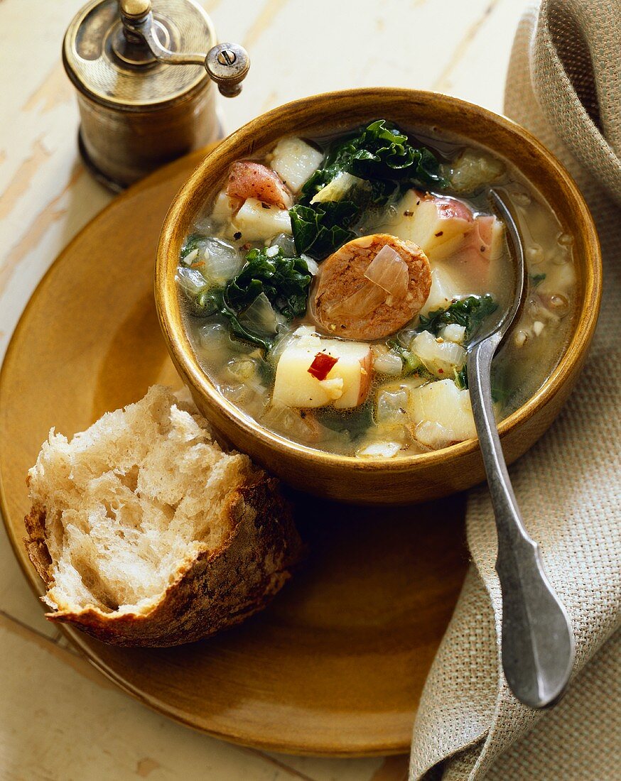 Hearty Potato, Sausage and Kale Soup; Piece of Crusty Bread