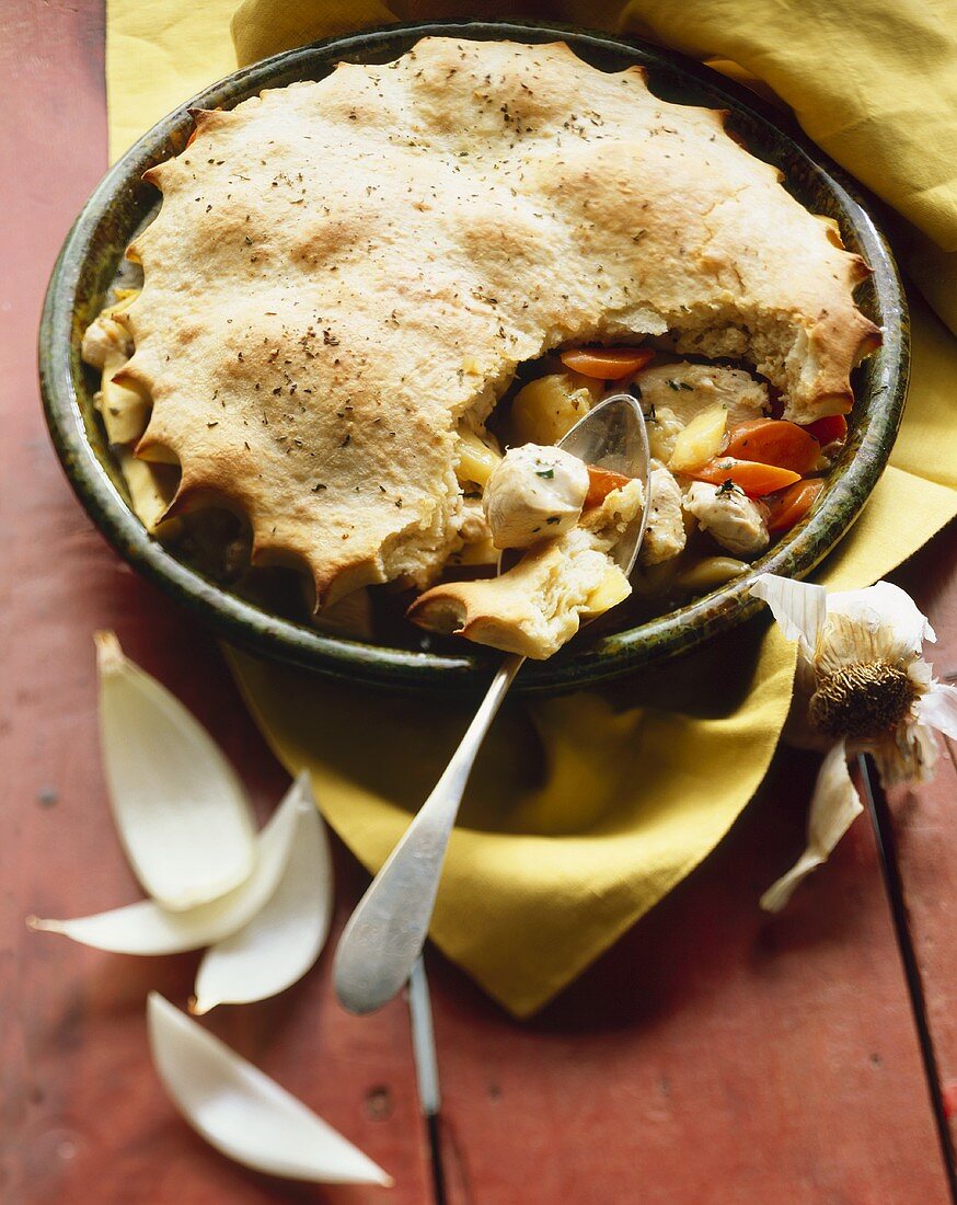 Chicken Pot Pie with Crust Partially Removed to Show Filling; Spoon
