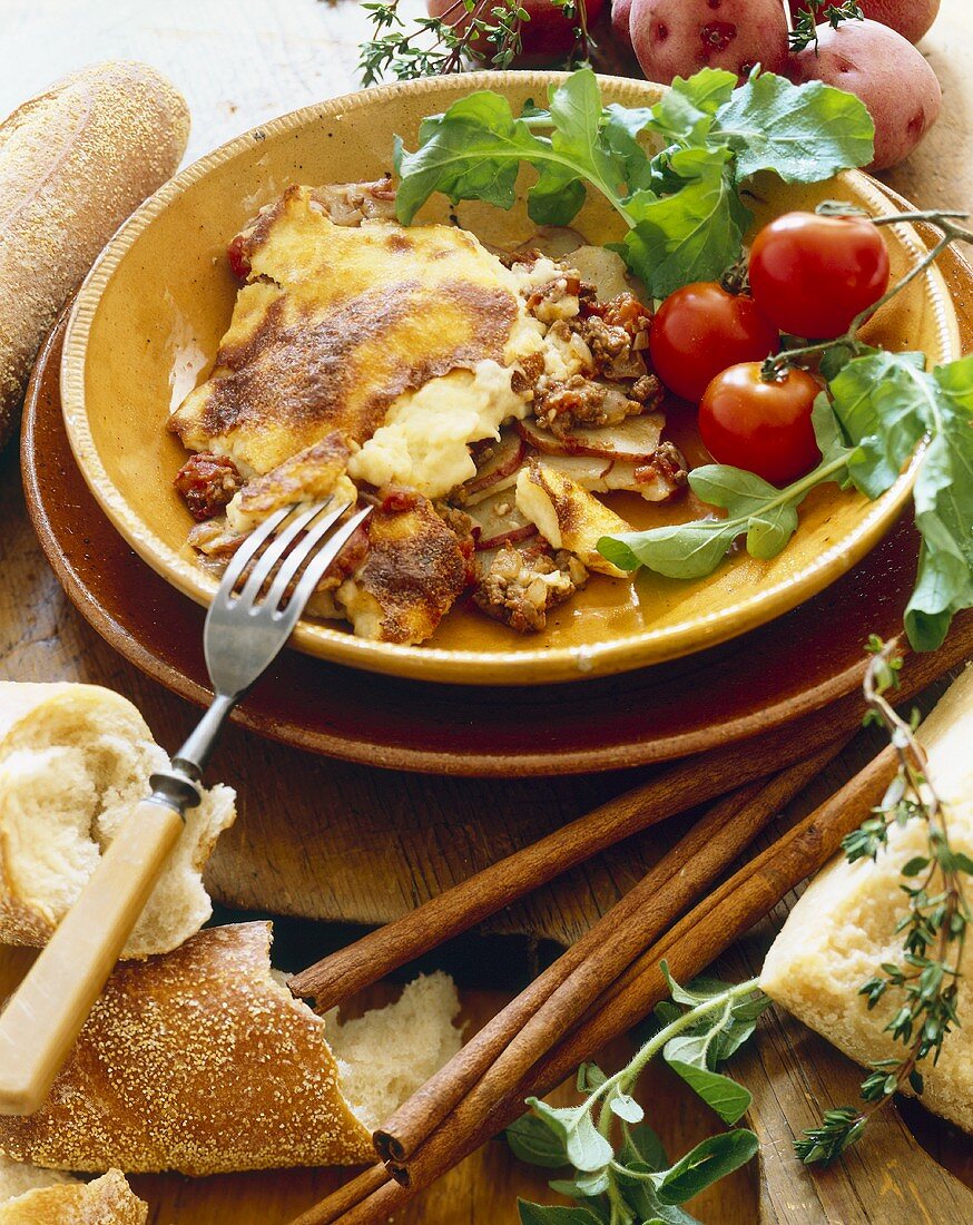 Potato Moussaka in a Bowl; Bread and Fresh Ingredients