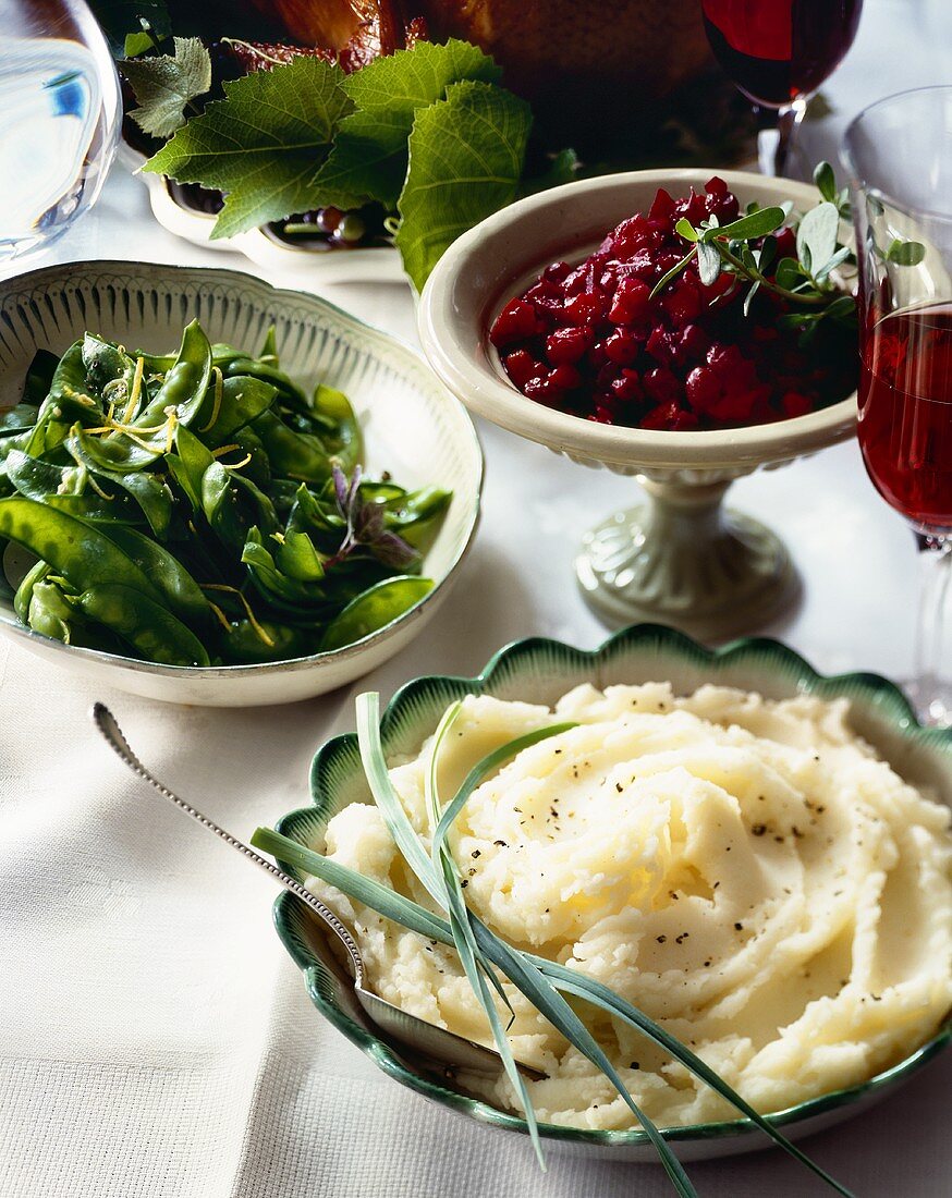 Side Dishes on Buffet Table; Mashed Potatoes, Snow Peas, Cranberry Sauce