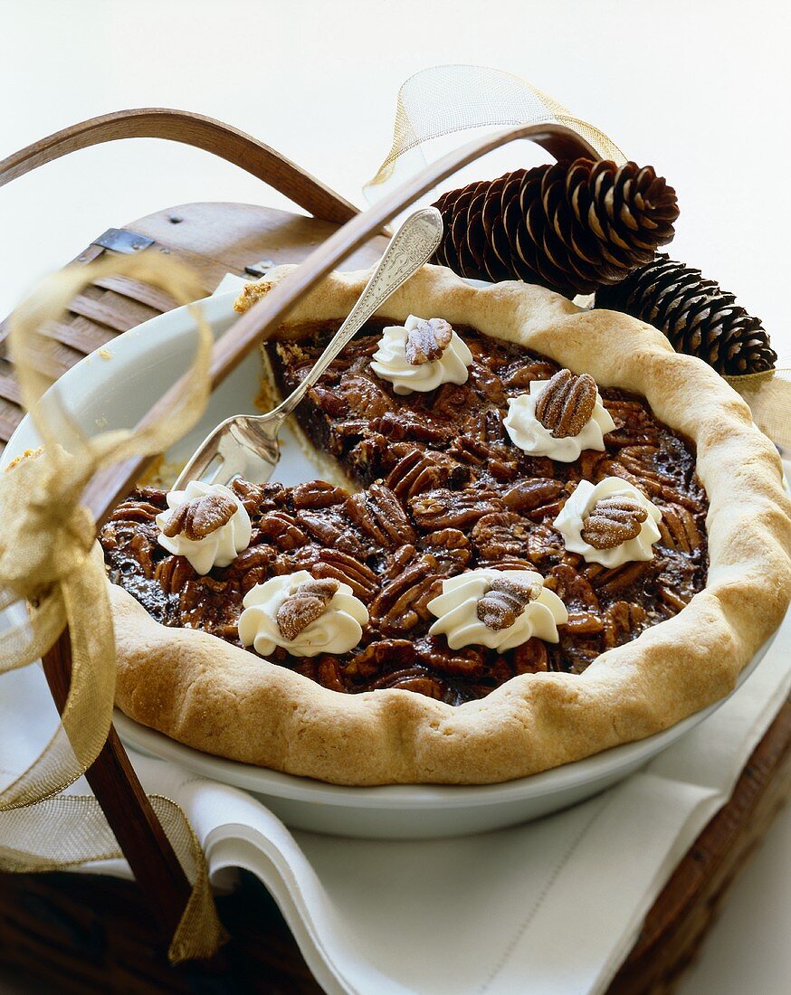Pecan Pie in Baking Dish With Slice Removed; On Basket with Ribbon