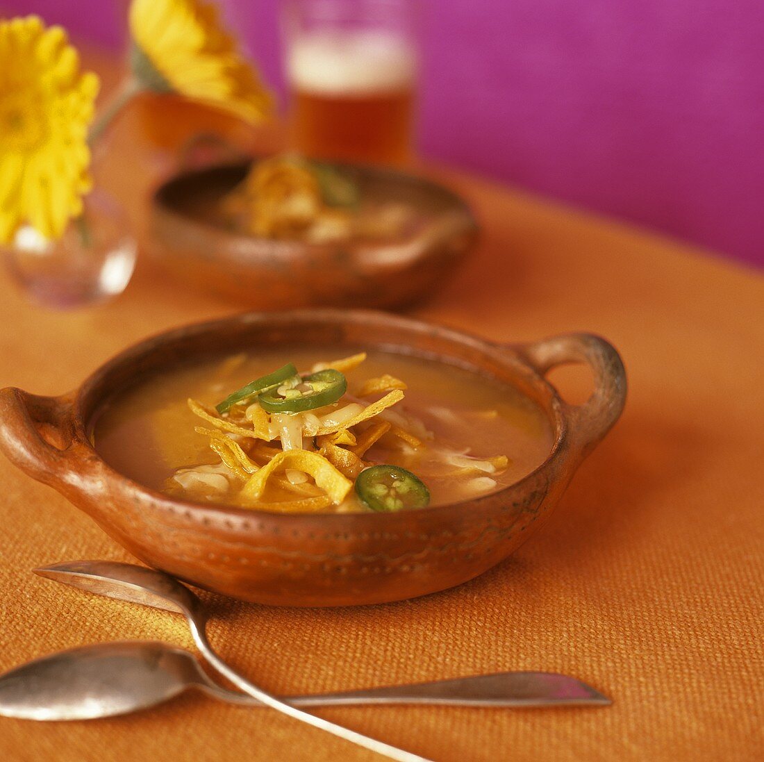 Bowl of Chicken Tortilla Soup with Jalapenos and Jack Cheese