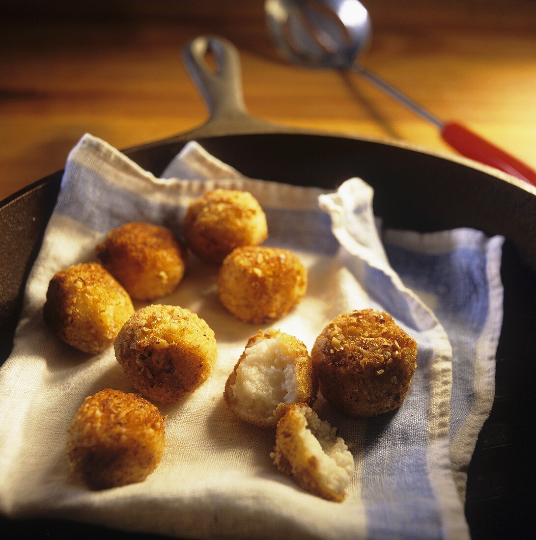 Hush Puppies on a Dish Cloth in Skillet