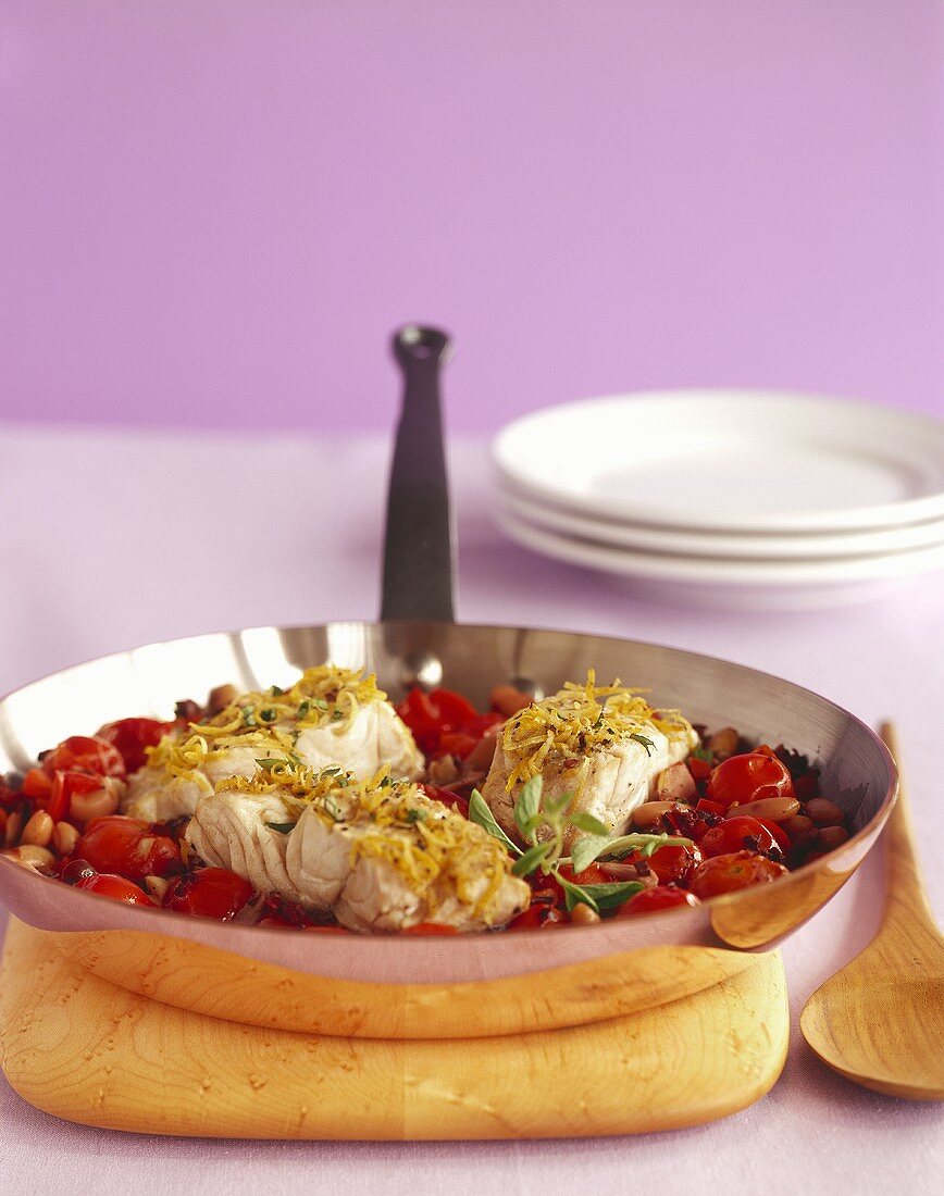 Pan of Sea Bass with Tomato and Beans; Wooden Serving Spoon