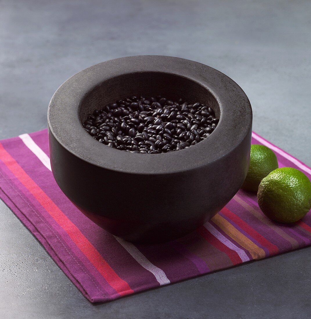 Black beans in a stone mortar