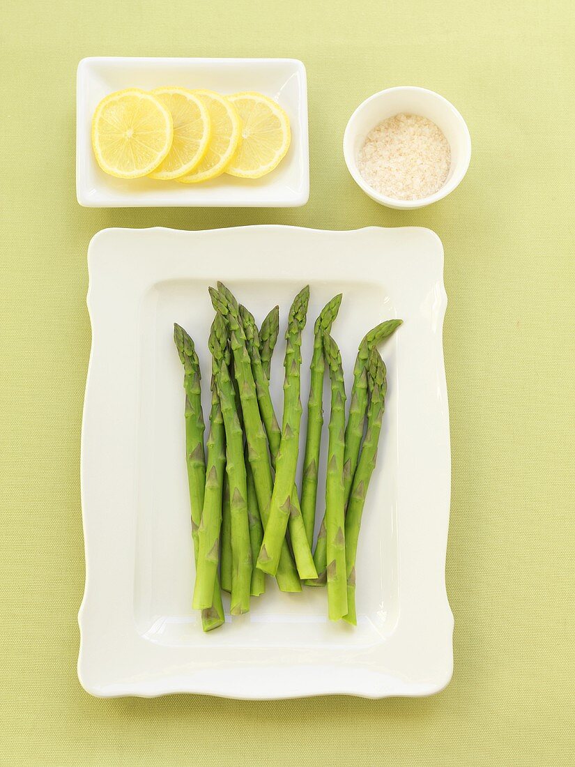 Steamed Asparagus on a Plate, Lemon Slices and Sea Salt
