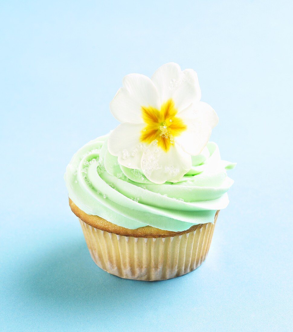 Cupcake with Green Butter Cream Frosting and Primrose Garnish