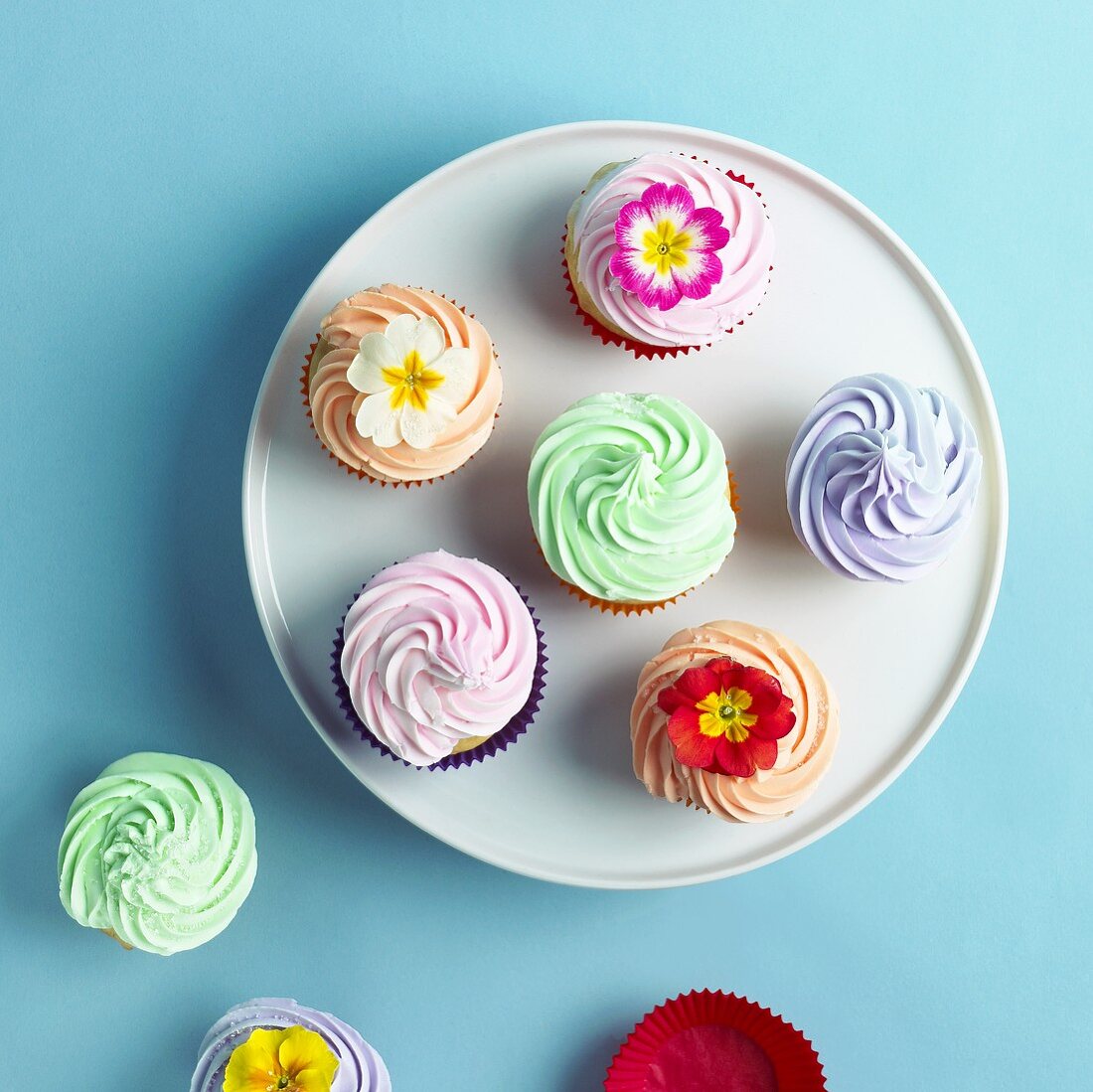 Pastel Cupcakes; Some with Flower Garnishes