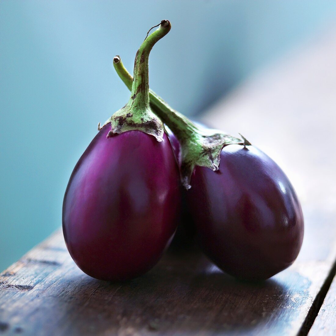 Small Group of Eggplants on Wooden Table