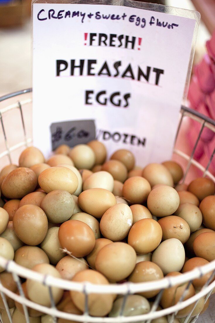 Pheasant Eggs in a Wire Basket at Farmer's Market; Sign