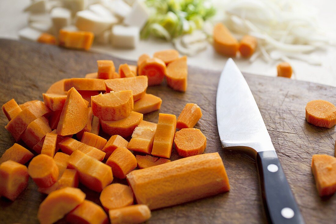Chopped Carrots on a Cutting Board with Knife
