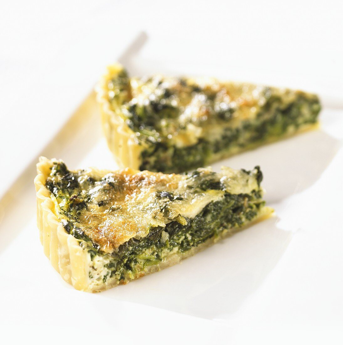 Two slices of spinach quiche