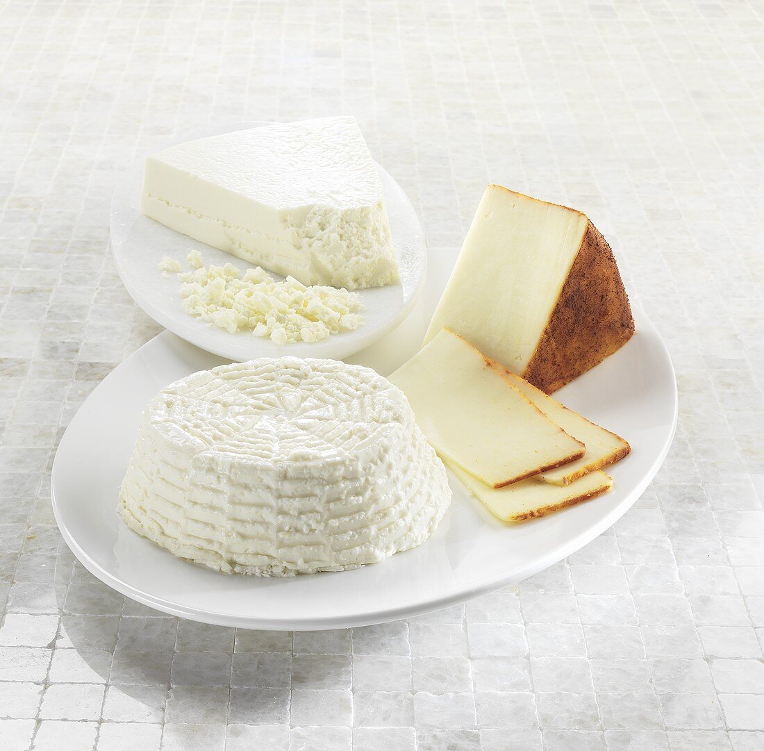 Three Assorted Cheeses on White Dishes