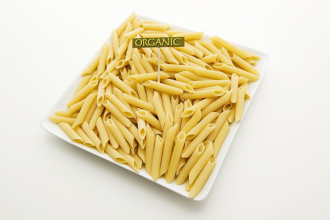 Bio-Penne mit Schild auf weißem Teller