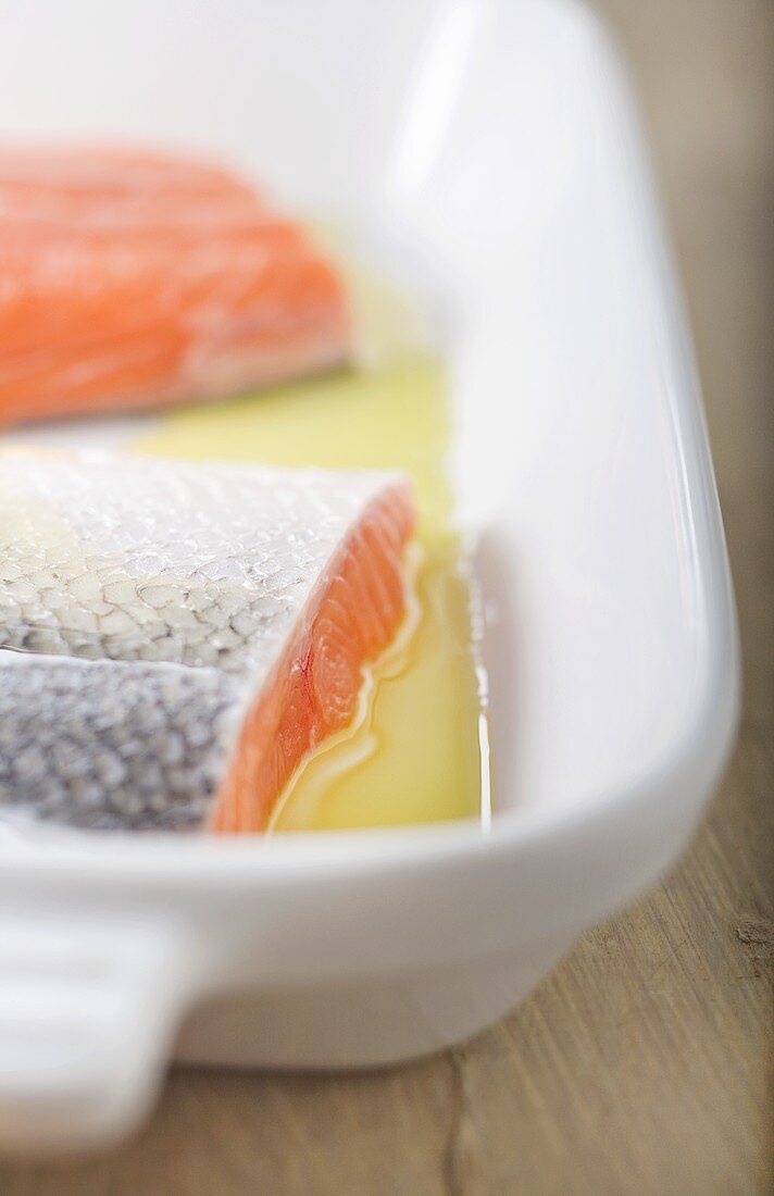 Raw Salmon Fillets with Skin in Olive Oil in Baking Dish