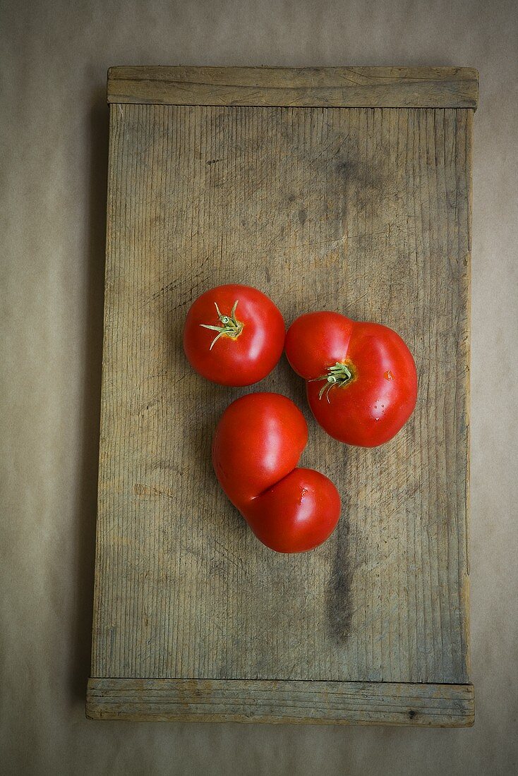 Fresh Red Tomatoes on a Wooden Board