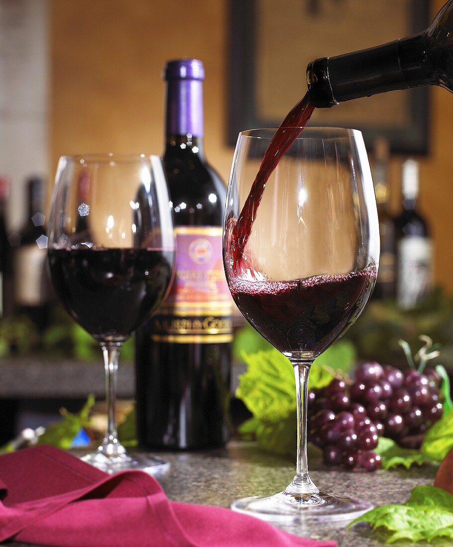 Red Wine Pouring into a Glass From Bottle