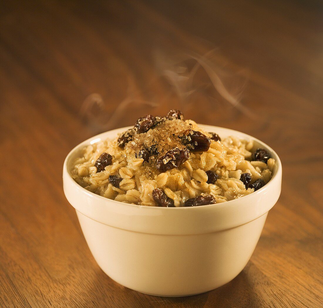 Bowl of Steaming Oatmeal with Raisins and Brown Sugar