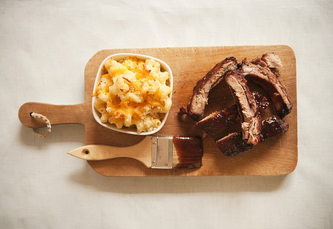 Sliced Barbecue Pork Ribs and Mac and Cheese on Cutting Board