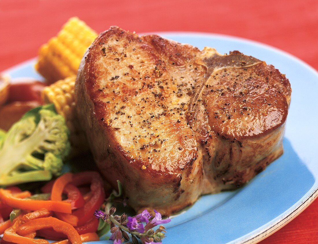 Baked Pork Chop with Mixed Veggies on a Blue Plate