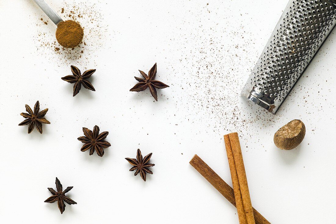 Star anise, cinnamon sticks and nutmeg with a grater