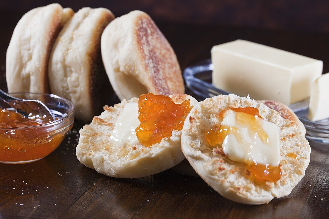 English Muffins with Butter and Marmalade on Wooden Table
