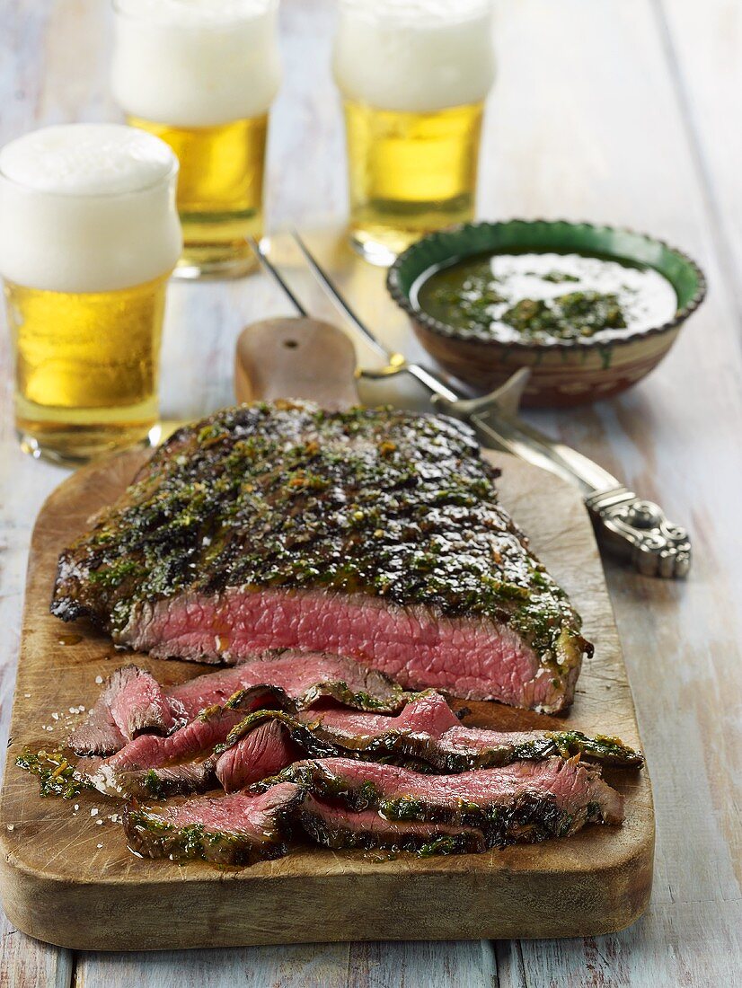 Grilled Flank Steak with Chimichurri Sauce; On Cutting Board; Beer