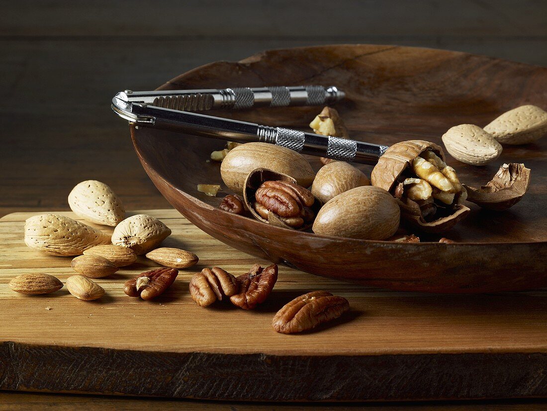 Mixed Nuts; Whole and Cracked in a Wooden Bowl with Crackers