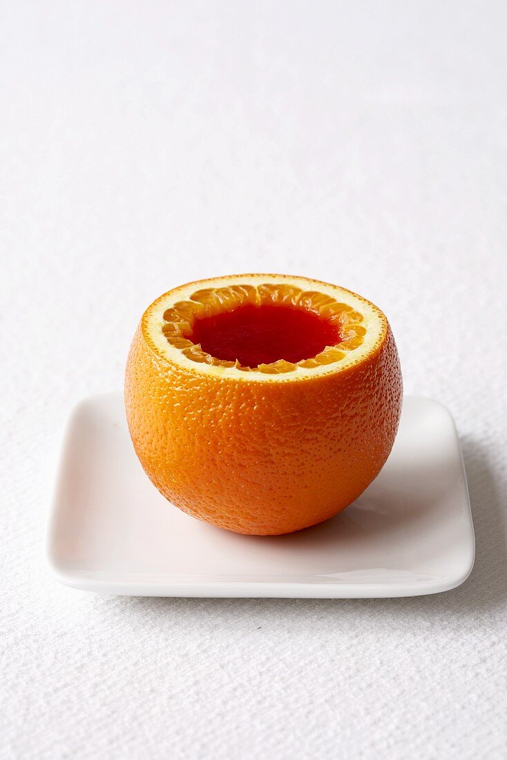 Jello Served in an Orange on a White Plate