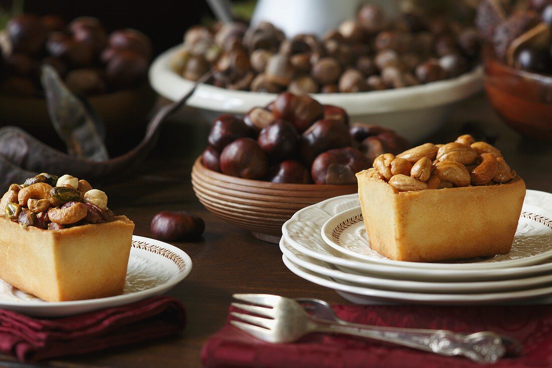 Individual Nut Tarts on Plates; Chestnuts and Acorns