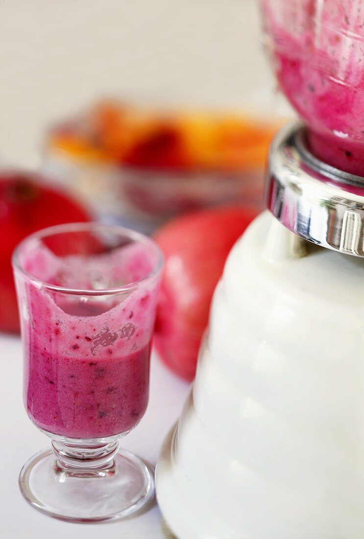 Pomegranate Fruit Smoothie in a Small Glass; Partially Consumed; Blender