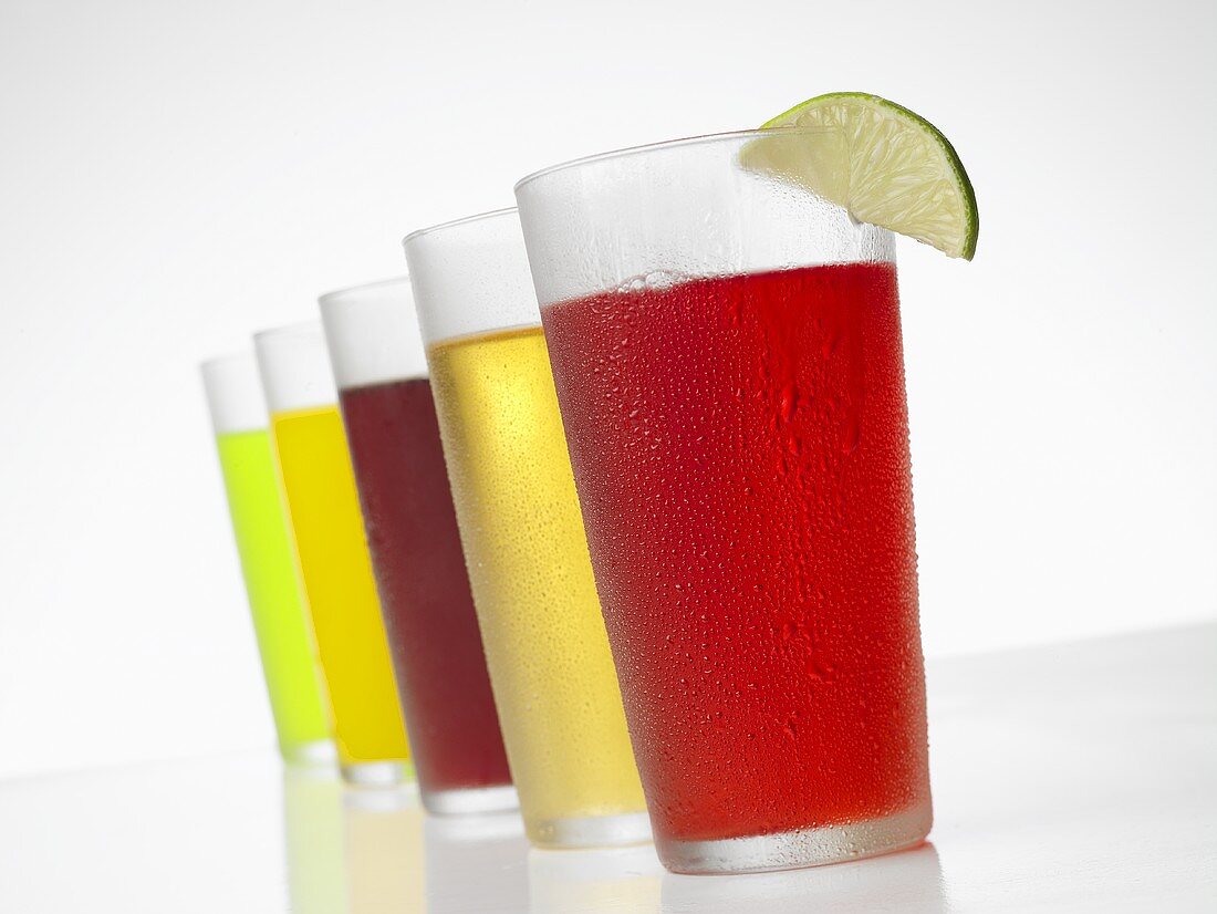 Glasses of Various Juices on White Background