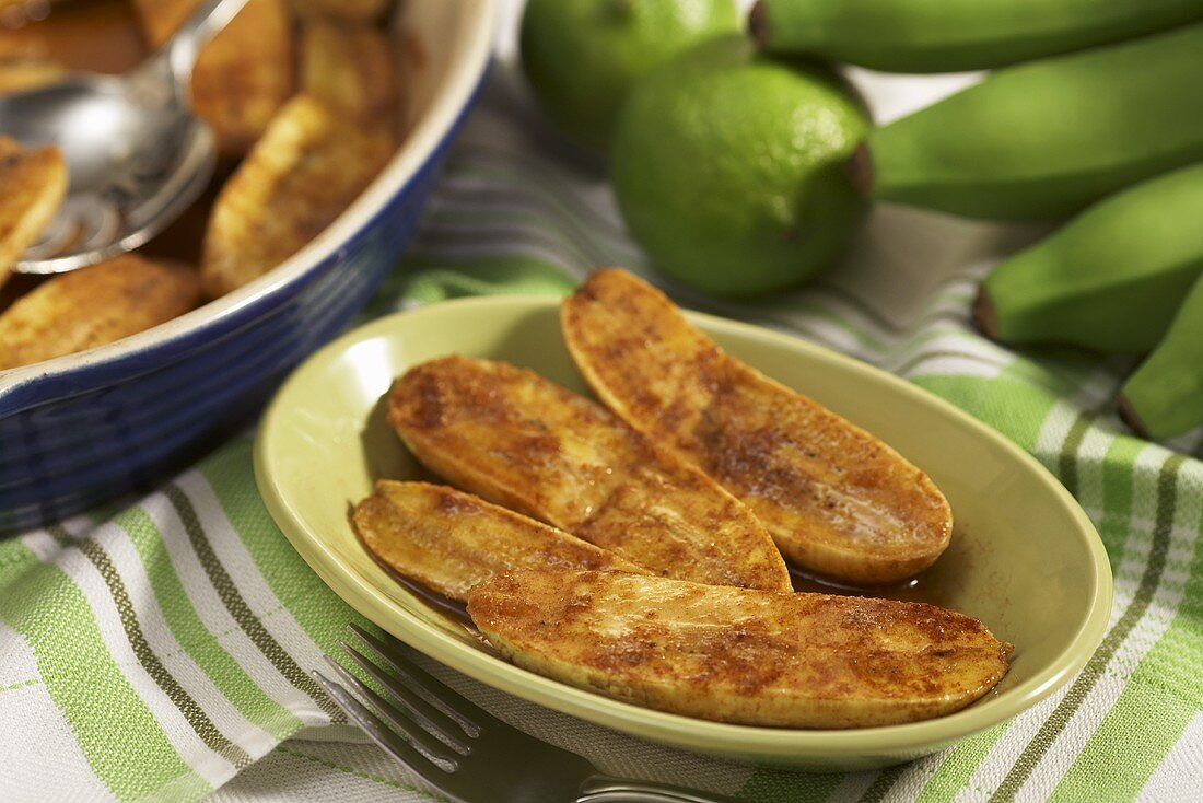 Baked Plantains in a Bowl; Baking Dish and Fresh Plantains