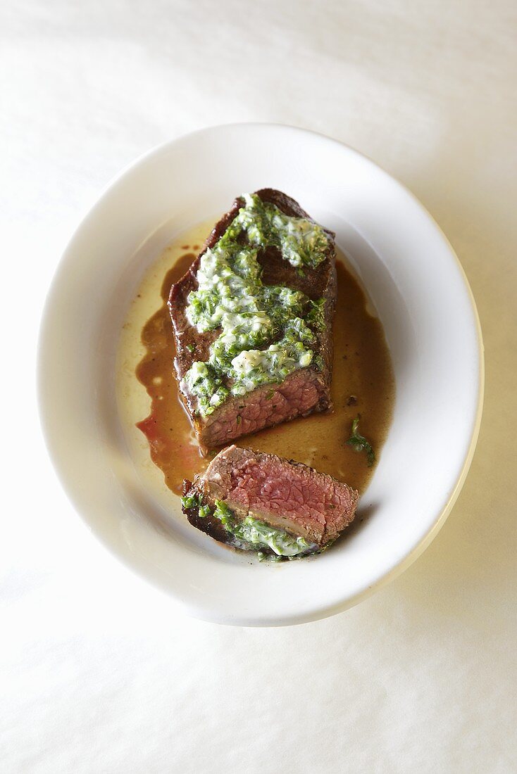 Beef steak with herb butter, partly sliced
