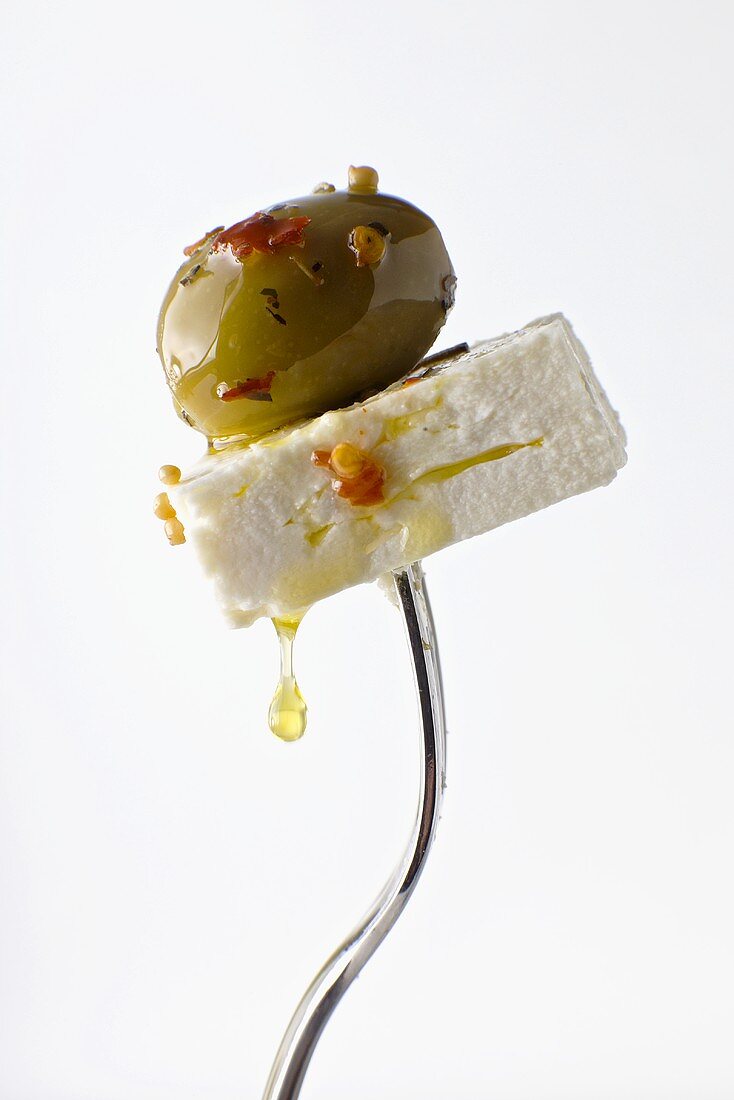 Feta Cheese and Marinated Green Olive Pierced on a Fork