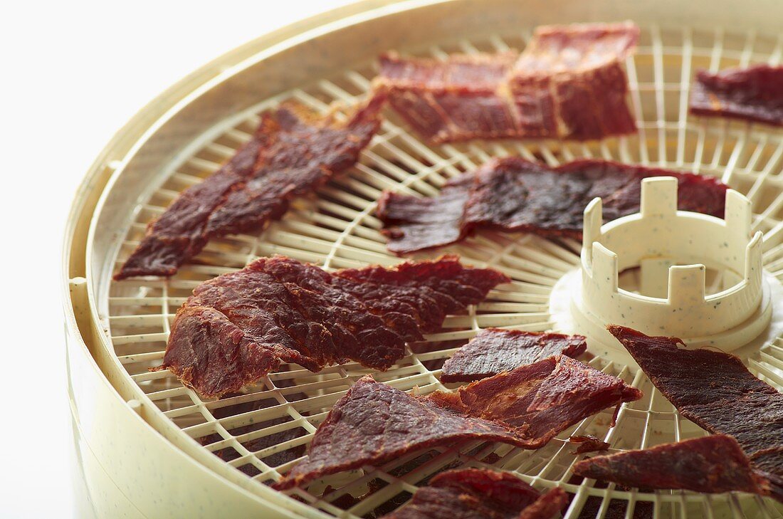 Slices of Teriyaki Spiced Beef Jerky on Dehydrator Trays