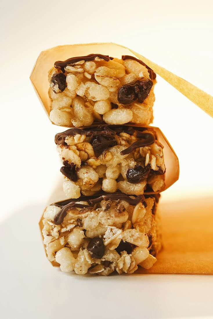 Three Chocolate Chip Rice and Oat Bars; Stacked with Paper