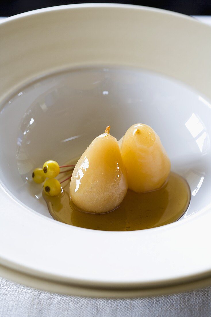 Two Baked Pears with Maple Syrup in a White Bowl