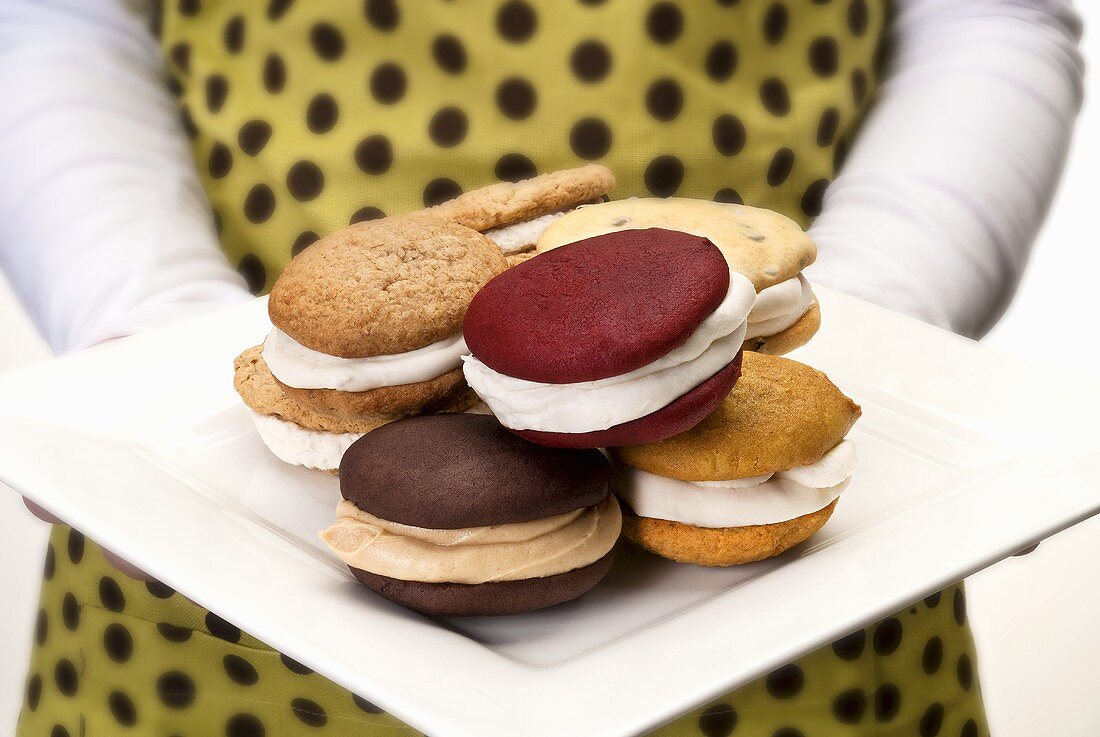 Woman Holding a Plate of Assorted Whoopie Pies