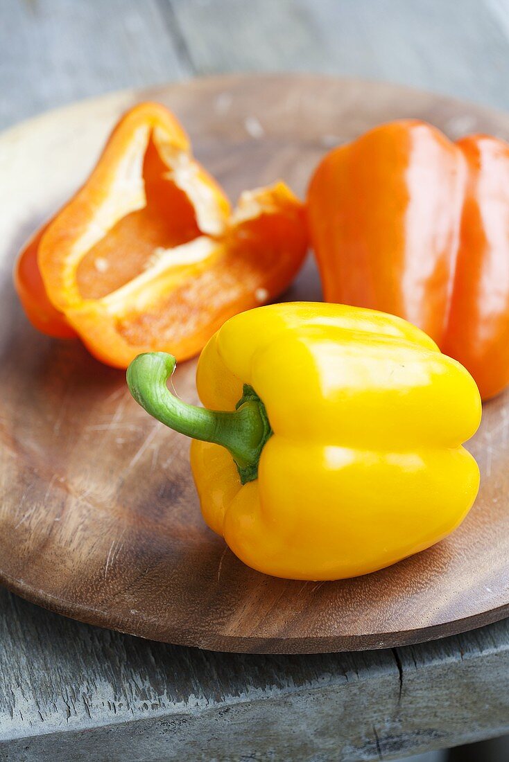 Yellow and Orange Bell Peppers on a Board
