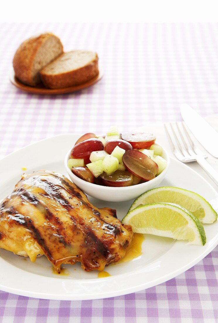 Grilled Citrus Chicken with Lime Wedges and Fruit Salad
