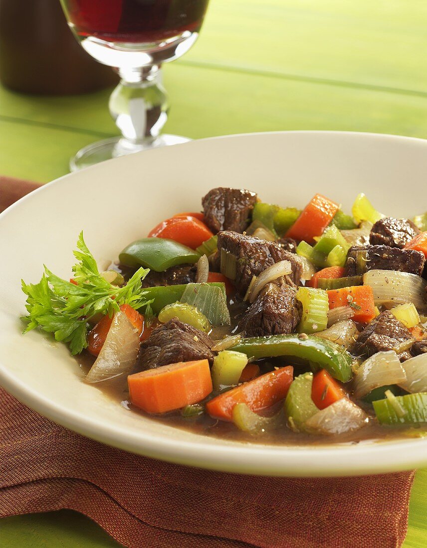 Bowl of Beef and Vegetable Soup; Glass of Red Wine