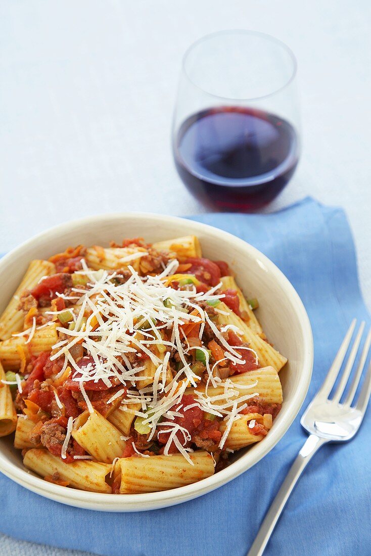 Bowl of Rigatoni with Tomato Meat Sauce; Glass of Red Wine